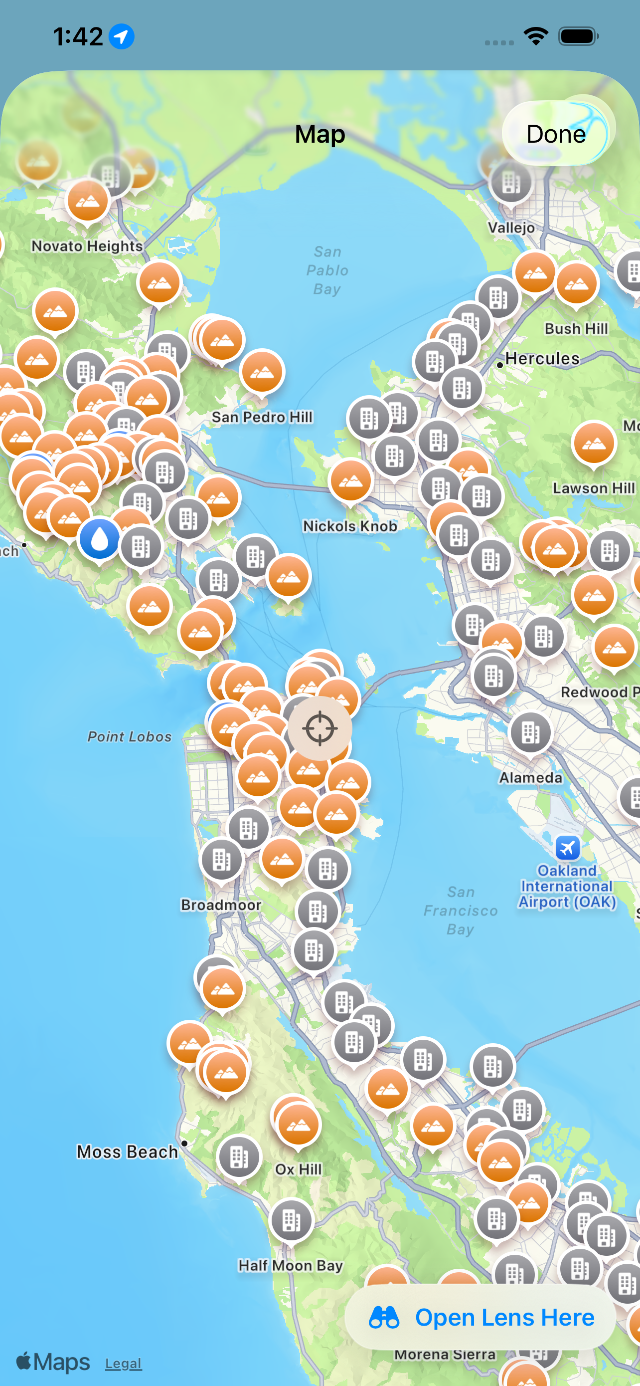 The map on iPhone &mdash; the San Francisco Bay covered in landmark pins, orange for summits and grey for populated places, from Novato Heights and San Pedro Hill round to Vallejo, Hercules, Alameda and Half Moon Bay, with the current position marked and an &lsquo;Open Lens Here&rsquo; button to swing the live view to that spot