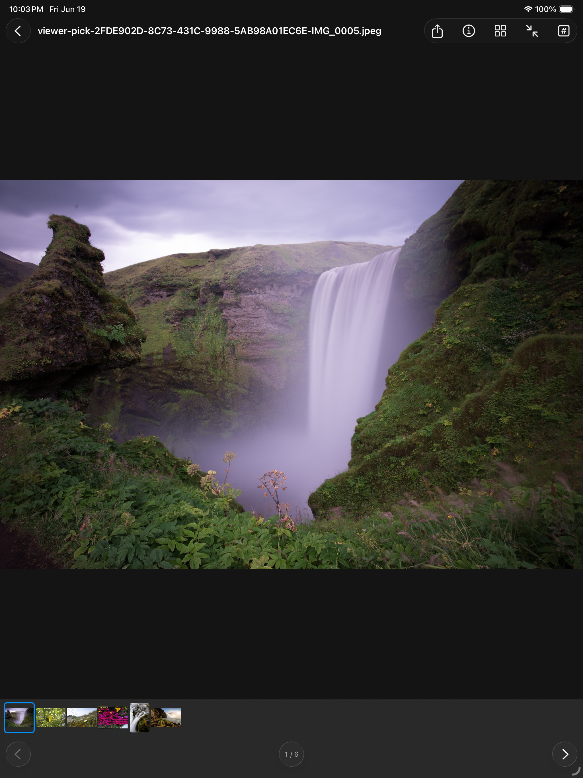 A photograph open on iPad &mdash; a long exposure of a waterfall under a violet sky filling the window, with a filmstrip of the other five images along the bottom, a 1 / 6 counter, and share, info, grid, fit and pixel-size controls in the toolbar